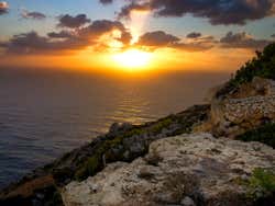 The sun lighting up the horizon as it sets