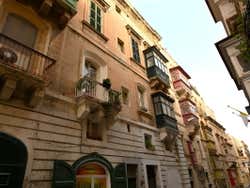 A narrow street with several balconies