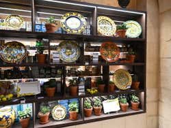 A shop window with shelves displaying handmade ceramics