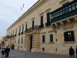 People outside the façade of the Gran Master's Palace