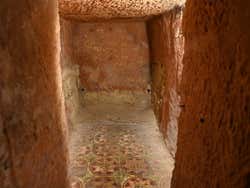 The interior of a catacomb with prints on the floor tiles