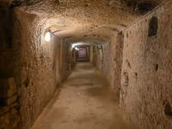 A narrow hall inside a catacomb