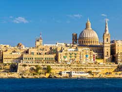 A view of a city along a coast under a blue sky