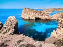 A view of rock formations in the sea on a sunny day