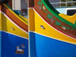 Brightly coloured fishing boats with painting on them
