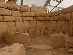 An exposed central chamber made from stone covered overhead